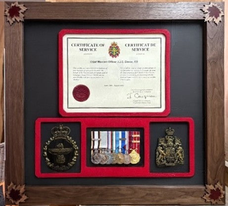 Custom frames and personalized plaques showcasing a military certificate and medals in a decorative display.