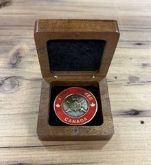 Engraved walnut coin boxs displaying an Army Canada coin in a rich wooden case.