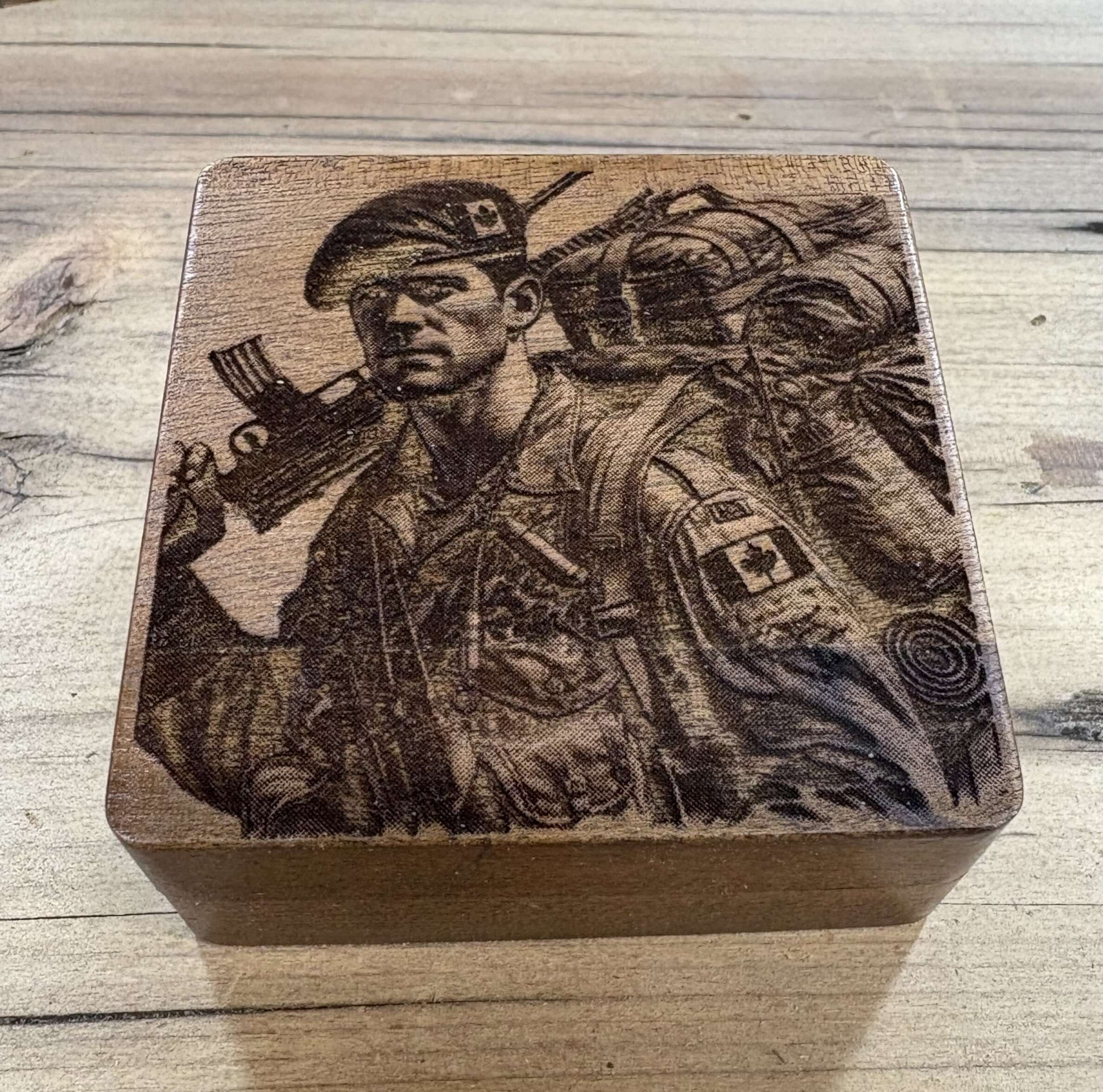 Engraved walnut coin boxs featuring a soldier carrying gear with a rifle, perfect for collectors and gifts.