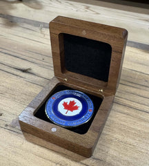 Engraved walnut coin boxs displaying a collectible coin with a Canadian flag design.