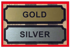 Gold and Silver nameplates displayed on a wooden background, ideal for awards and recognition.