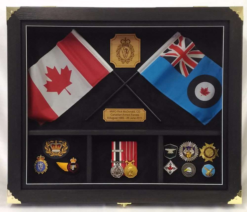 Coliseum shadow box display showcasing Canadian and military memorabilia with flags and medals.