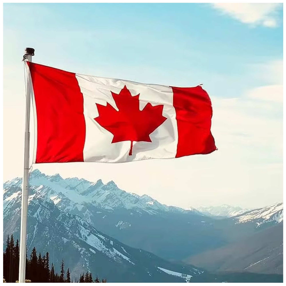 embroidered Canadian flag waving against a mountain backdrop under a clear blue sky.
