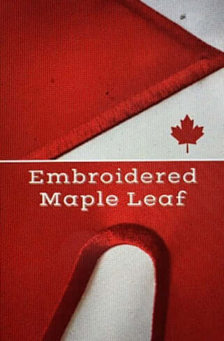 Close-up view of an embroidered Canadian flag patch with a prominent maple leaf.
